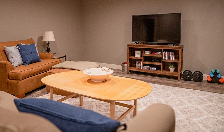 finished basement with furniture and TV